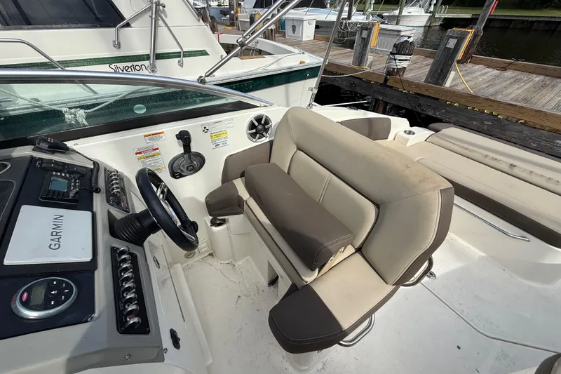 Slide: The Image of 2015 Sea Ray 260 Sundancer cockpit with Garmin navigation, docked at marina. - 9