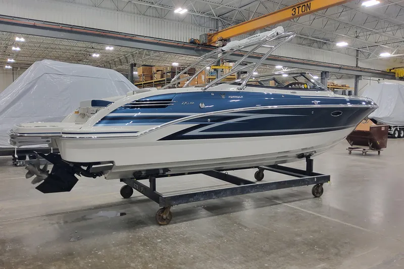 The Image of 2026 Formula 270 Bowrider boat in a warehouse, showcasing sleek design and modern features. - 1