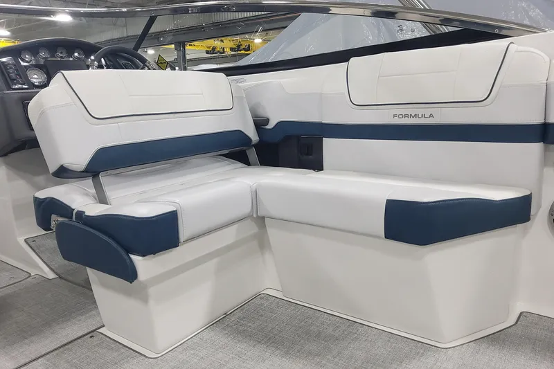 Slide: The Image of 2026 Formula 270 Bowrider interior with white and blue seating, modern design. - 11