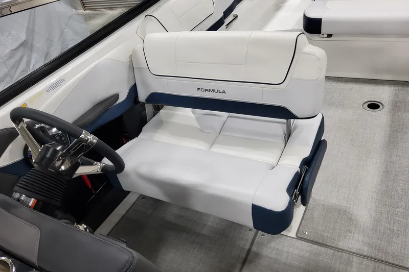 Slide: The Image of 2026 Formula 270 Bowrider interior with white and blue seating and steering wheel. - 22