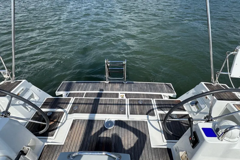 Slide: The Image of Beneteau Oceanis 45 yacht deck, 2013 model, featuring dual steering wheels and swim platform. - 10