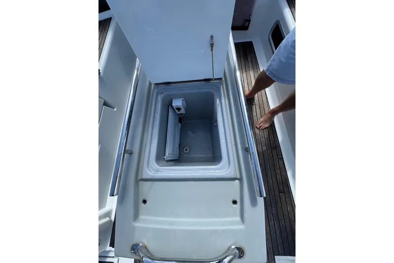 Slide: The Image of 2013 Beneteau Oceanis 45 yacht cockpit storage compartment with open lid and visible interior. - 13