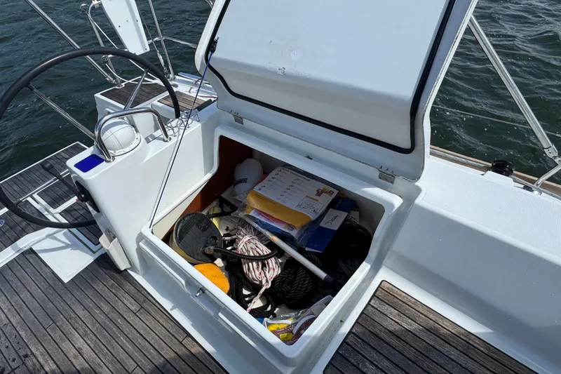 Slide: The Image of Open storage compartment on 2013 Beneteau Oceanis 45 sailboat, containing ropes and equipment. - 14