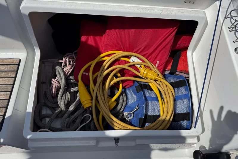 Slide: The Image of Storage compartment on a 2013 Beneteau Oceanis 45 with ropes, cables, and life jackets. - 15