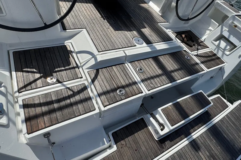 Slide: The Image of Teak deck of 2013 Beneteau Oceanis 45 sailboat, featuring storage compartments and steps. - 16