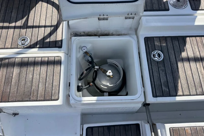 Slide: The Image of Beneteau Oceanis 45 (2013) deck with open storage compartment and propane tank. - 17