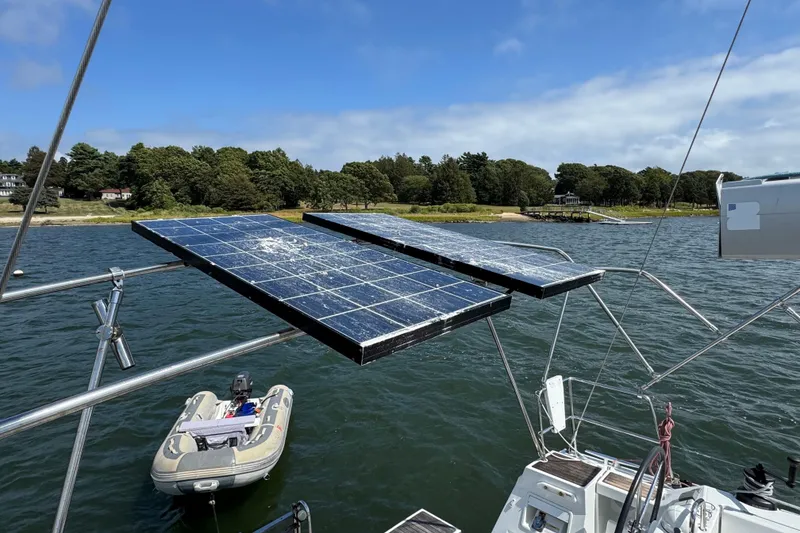 Slide: The Image of Sailboat with solar panels, Beneteau Oceanis 45, 2013 model, anchored near a scenic shoreline. - 18