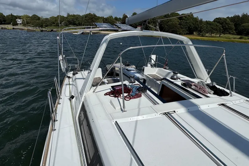 Slide: The Image of 2013 Beneteau Oceanis 45 sailboat on calm water, featuring a spacious deck and rigging. - 19