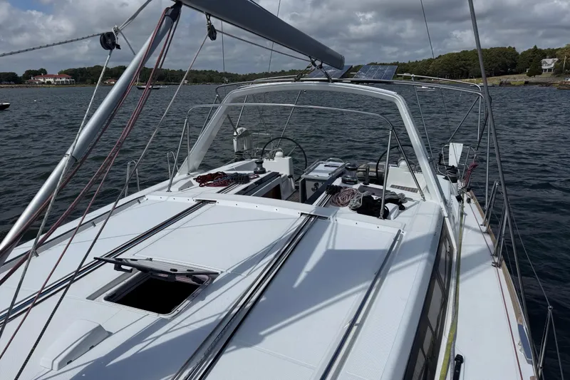 Slide: The Image of 2013 Beneteau Oceanis 45 sailboat on calm water, showcasing deck and rigging. - 20