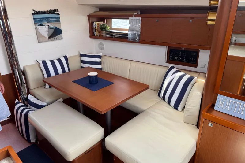 Slide: The Image of Interior of 2013 Beneteau Oceanis 45 yacht with cozy seating and nautical decor. - 27