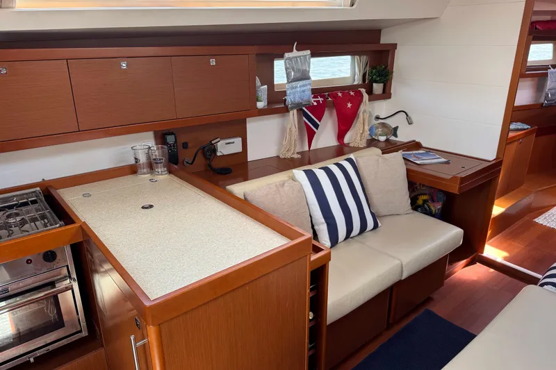 Slide: The Image of Interior of 2013 Beneteau Oceanis 45 yacht with cozy seating and modern kitchen. - 28