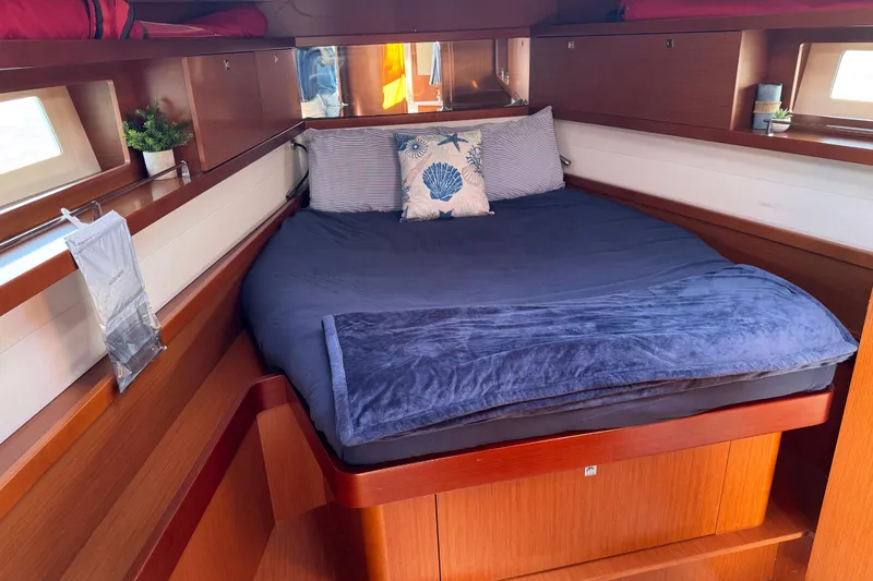 Slide: The Image of Cozy cabin interior of 2013 Beneteau Oceanis 45 with plush bedding and wooden finish. - 30