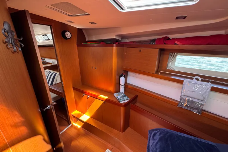 Slide: The Image of Interior of 2013 Beneteau Oceanis 45 yacht, featuring wooden cabinetry and nautical decor. - 33