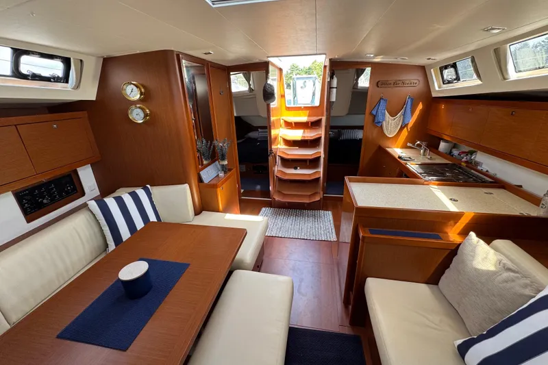 Slide: The Image of Luxurious interior of a 2013 Beneteau Oceanis 45 yacht with elegant wood finishes. - 34
