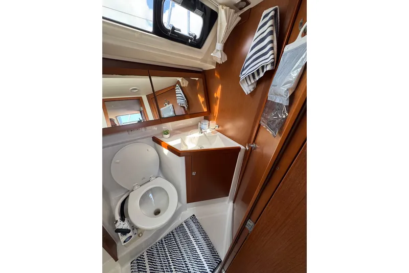 Slide: The Image of Bathroom interior of 2013 Beneteau Oceanis 45 yacht, featuring toilet and sink. - 39