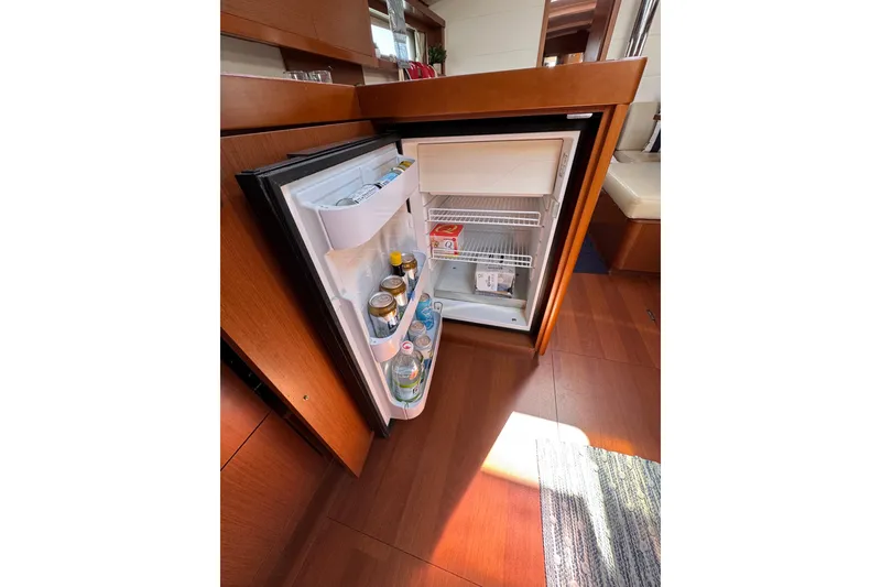Slide: The Image of Open fridge inside 2013 Beneteau Oceanis 45 yacht, stocked with beverages and food. - 44