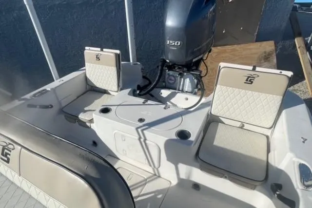 Slide: The Image of 2021 Carolina Skiff 21 LS boat interior with seating and 150 HP outboard motor. - 10