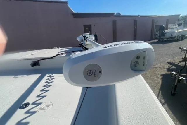 Slide: The Image of 2021 Carolina Skiff 21 LS boat with Minn Kota trolling motor in a sunny outdoor setting. - 14