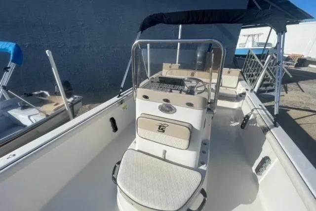 Slide: The Image of 2021 Carolina Skiff 21 LS boat with center console and seating, docked outdoors. - 15