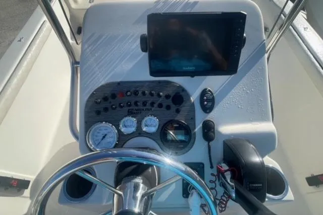 Slide: The Image of 2021 Carolina Skiff 21 LS boat dashboard with steering wheel and navigation controls. - 19