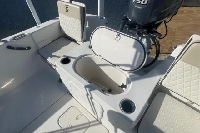 Slide: The Image of 2021 Carolina Skiff 21 LS boat interior with storage compartments and Yamaha motor. - 20