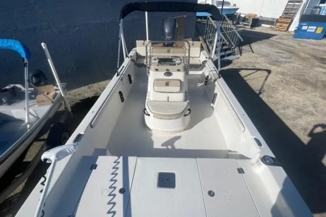 Slide: The Image of 2021 Carolina Skiff 21 LS boat with spacious deck and seating, docked outdoors. - 22