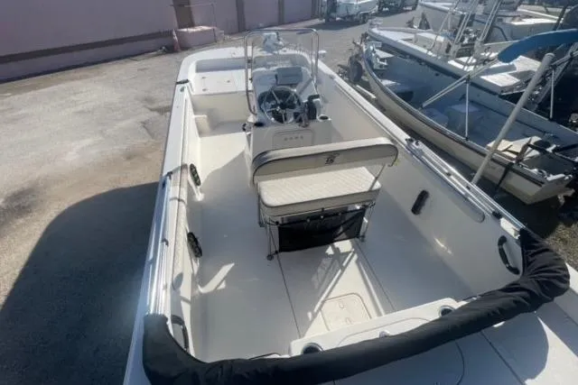 Slide: The Image of 2021 Carolina Skiff 21 LS boat with center console and seating, docked outdoors. - 26