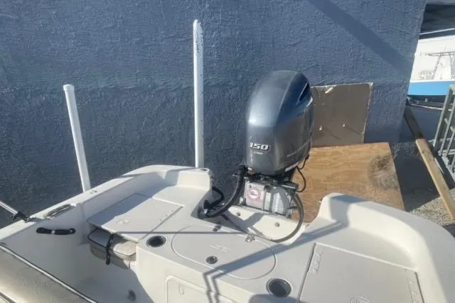 Slide: The Image of 2021 Carolina Skiff 21 LS boat with 150 HP outboard motor, docked outdoors. - 9