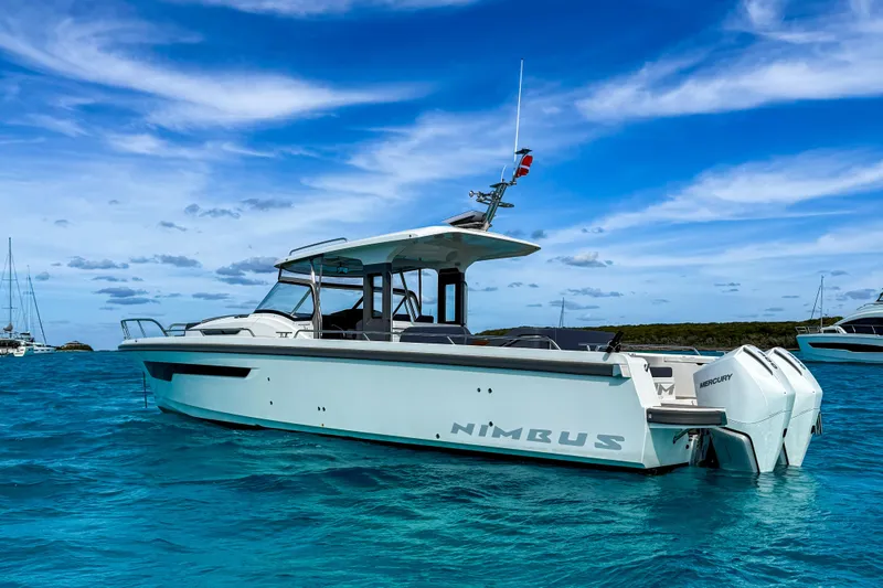 The Image of Nimbus T11 2022 boat on clear blue water under a vibrant sky. - 0