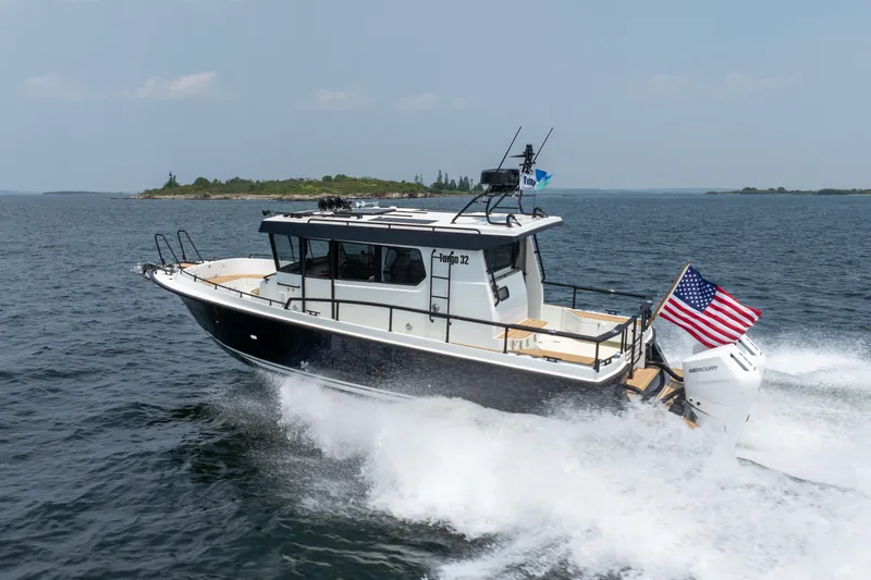 Slide: The Image of 2026 Targa 32 GT boat cruising on open water with American flag. - 1