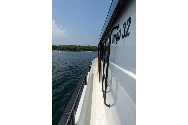 Slide: The Image of 2026 Targa 32 GT boat side view on calm water. - 16