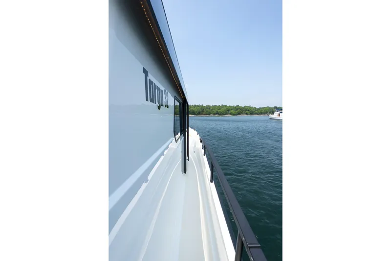 Slide: The Image of 2026 Targa 32 GT yacht side view on calm water, clear sky background. - 17