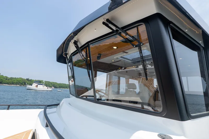 Slide: The Image of 2026 Targa 32 GT boat with sleek design, docked on calm waters. - 24