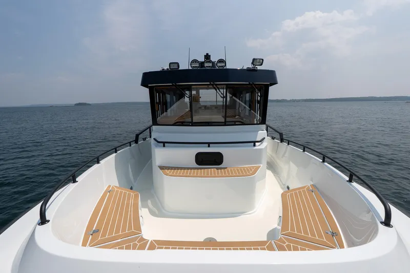 Slide: The Image of 2026 Targa 32 GT boat on open water, showcasing sleek design and spacious deck. - 25