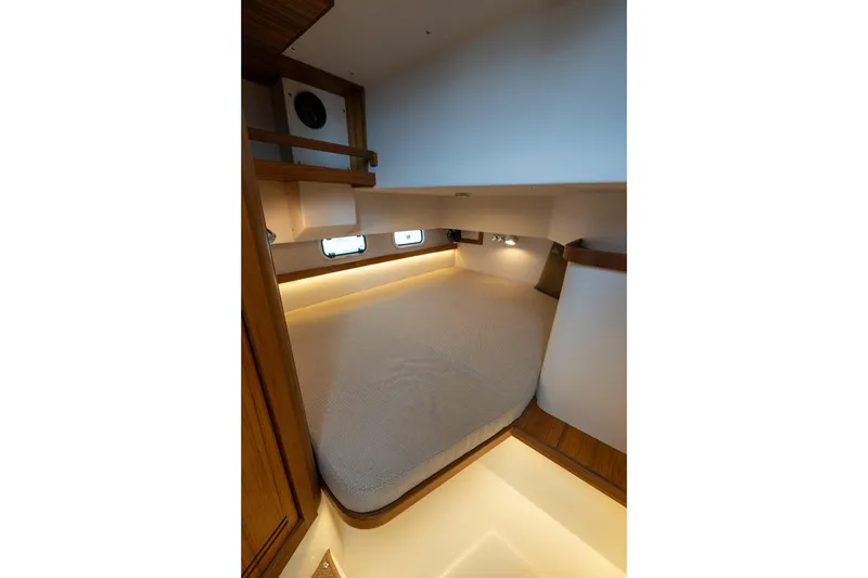 Slide: The Image of 2026 Targa 32 GT cabin interior with cozy bed and ambient lighting. - 42
