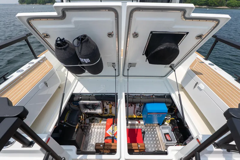 Slide: The Image of Open engine compartment of 2026 Targa 32 GT boat, showcasing equipment and storage. - 8