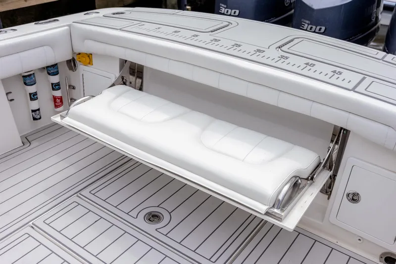 Slide: The Image of 2019 Regulator 34 boat with fold-down seat and storage compartments. - 14