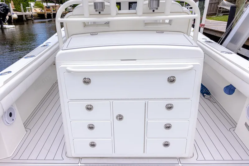 Slide: The Image of 2019 Regulator 34 boat interior with storage drawers and sleek white design. - 15