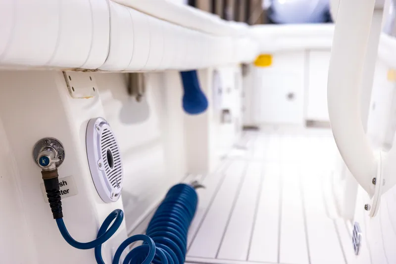 Slide: The Image of Interior view of 2019 Regulator 34 boat with coiled blue hose and speaker. - 18