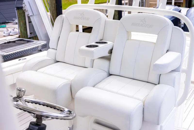 Slide: The Image of 2019 Regulator 34 boat with luxurious white seating and cup holders. - 22