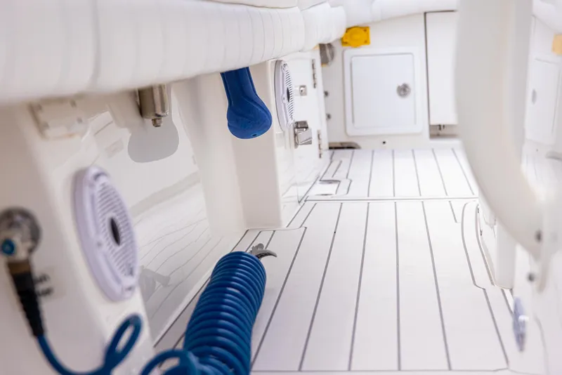 Slide: The Image of Interior view of 2019 Regulator 34 boat, featuring clean white deck and blue coiled hose. - 6