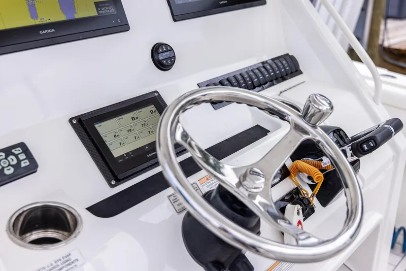 Slide: The Image of 2019 Regulator 34 boat helm with steering wheel and navigation controls. - 7