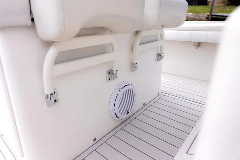 Slide: The Image of 2019 Regulator 34 boat interior with white seating and speaker. - 9