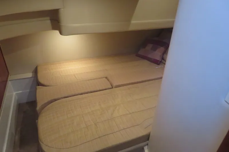 Slide: The Image of 2006 Carver 38 Super Sport cabin with twin beds and cozy lighting. - 10