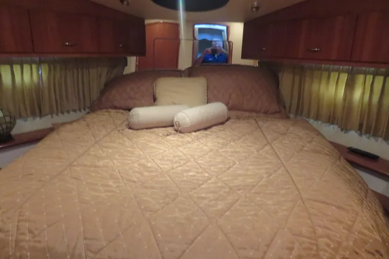 Slide: The Image of Interior cabin of 2006 Carver 38 Super Sport with cozy bed and wooden cabinets. - 11
