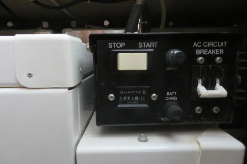 Slide: The Image of Control panel of a 2006 Carver 38 Super Sport boat with start, stop, and circuit breaker. - 18