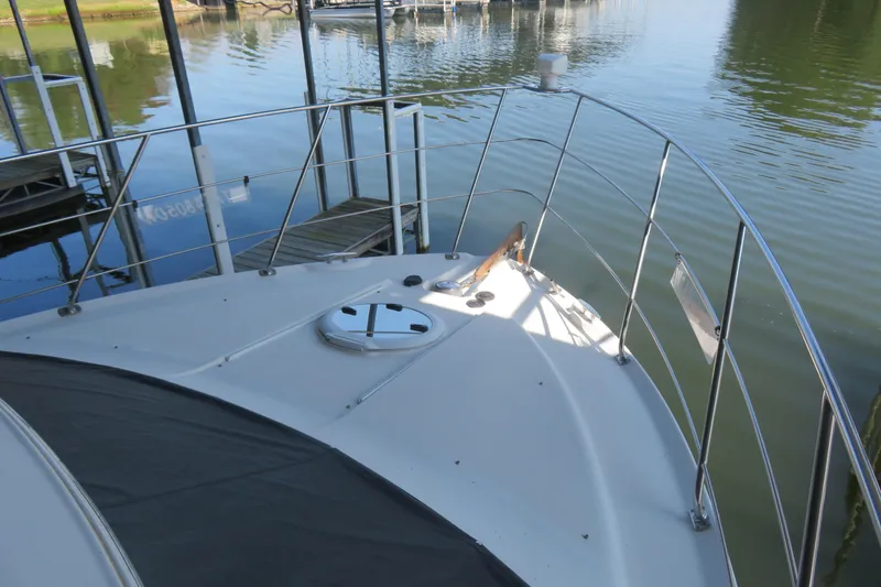 Slide: The Image of 2006 Carver 38 Super Sport yacht bow view at marina dock. - 19