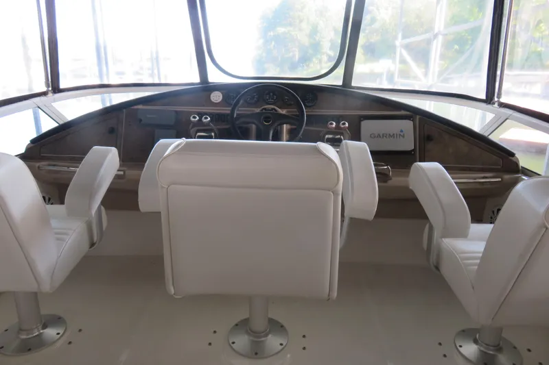 Slide: The Image of 2006 Carver 38 Super Sport helm with white seats and Garmin navigation system. - 3