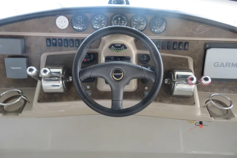 Slide: The Image of 2006 Carver 38 Super Sport helm with steering wheel, gauges, and navigation equipment. - 4