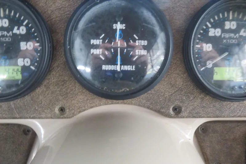 Slide: The Image of 2006 Carver 38 Super Sport dashboard with RPM and rudder angle gauges. - 5